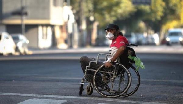 A person in a wheelchair asks for coins on the streets this Monday, one month after the mandatory quarantine for the COVID-19 virus, in Buenos Aires, Argentina. April 20, 2020.