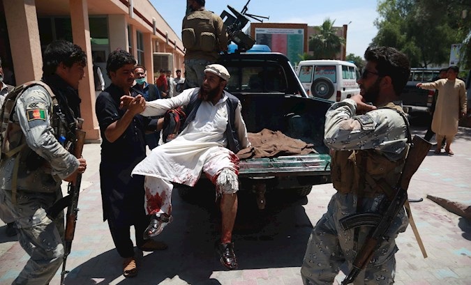 Security officials shift injured victims of a suicide bomb attack to a hospital, Jalalabad, Afghanistan, May 12, 2020.