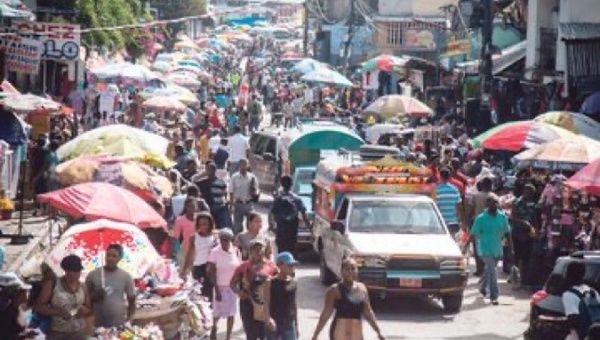 People walk down a crowded street in Port-au-Prince, Haiti, 2020.