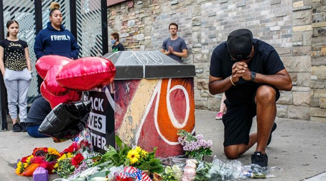 A protester prays in front of the memorial of George Floyd who died in custody on May 26, 2020 in Minneapolis.