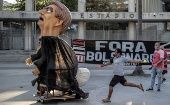 A man kicks a Bolsonaro doll at Maracana Stadium, Rio de Janeiro, Brazil, August 6, 2020.
