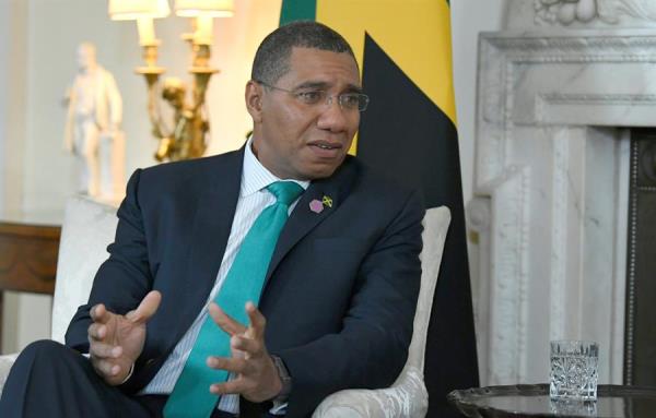Jamaican Prime Minister Andrew Holness converses with his British counterpart, Theresa May, during a meeting in London, United Kingdom. April 17, 2018.