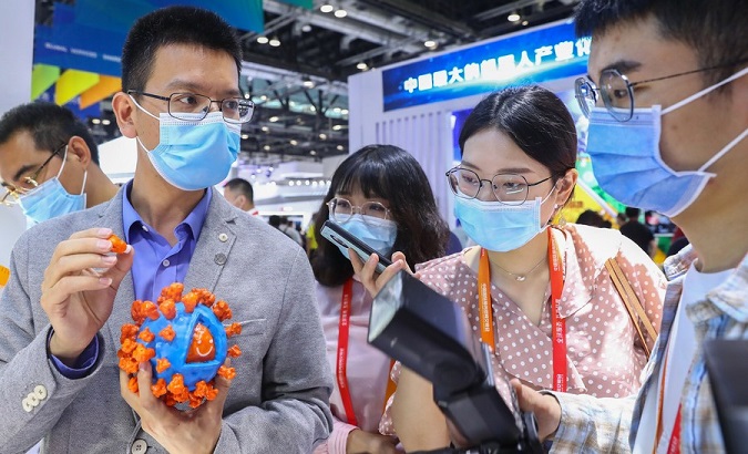 An exhibitor shows a 3D model of inactivated COVID-19 vaccine antigen at the International Fair for Trade in Services, Beijing, China, Sept. 5, 2020.