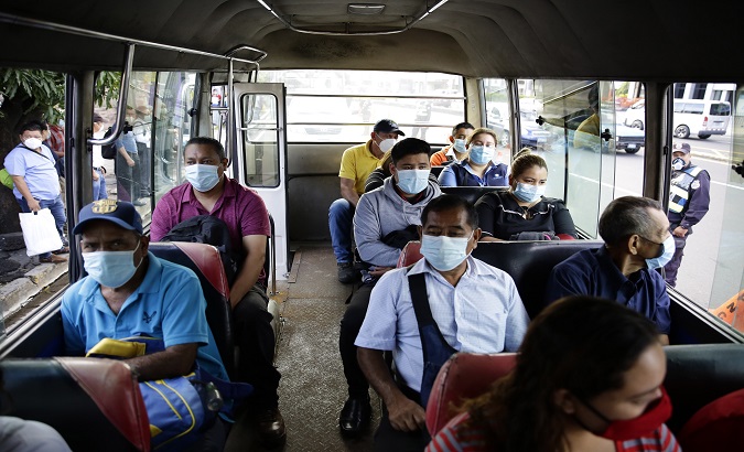 People travelling on a public transport bus in San Salvador, El Salvador. September 9, 2020.