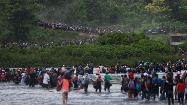 The immigrant caravan crosses a river on its way to the U.S.-Mexico border. Oct. 2, 2020.