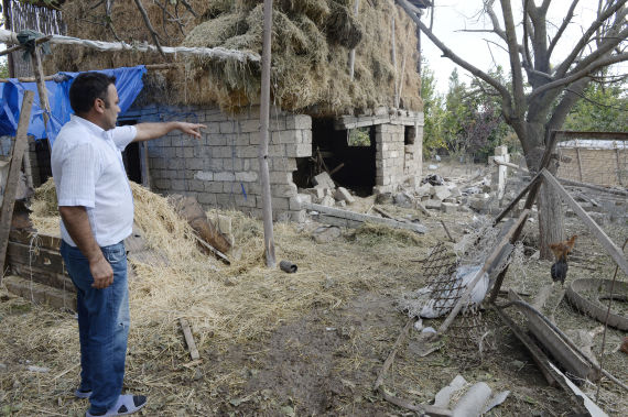A man shows a house damaged during the new round of Nagorno-Karabakh conflict between Azerbaijan and Armenia in Fuzuli district of Azerbaijan, Sept. 30, 2020.