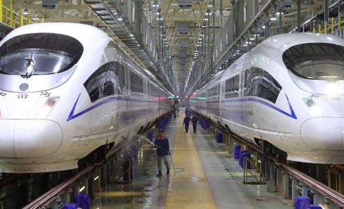 A staff member cleans the exterior of a bullet train, Shenyang, China, Jan. 8, 2020.