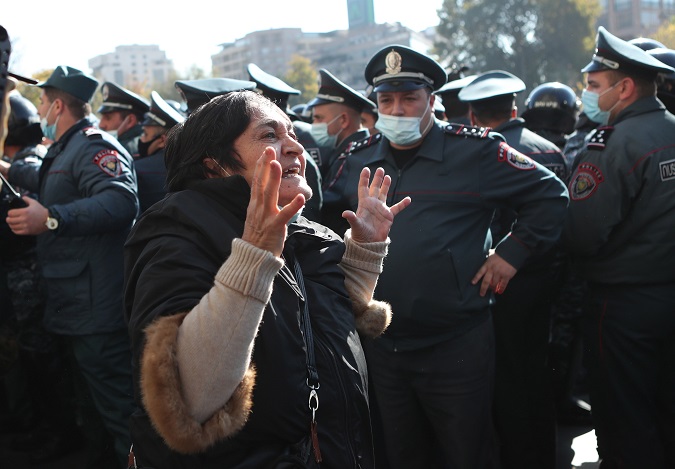 A woman reacts during an opposition rally in Yerevan, Armenia, 11 November 2020. Protesters demand the resignation of Armenian Prime Minister Nikol Pashinyan and his government.