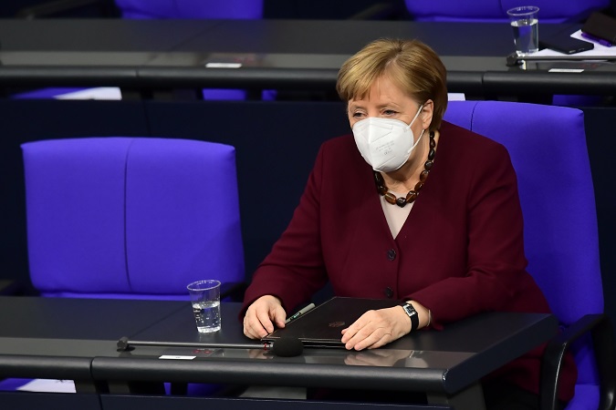 German Chancellor Angela Merkel wearing a face mask sits on her place prior to delivering a speech to the German Bundestag in Berlin, Germany, 26 November 2020.
