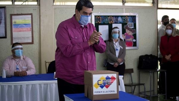 Venezuelan President Nicolas Maduro voted today at an electoral center in Caracas, Venezuela and asked Venezuelans to settle their differences through debate, 