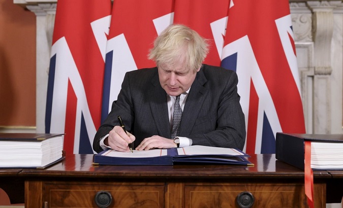 PM Boris Johnson signs the post-Brexit trade deal, London, Britain, Dec. 30, 2020.