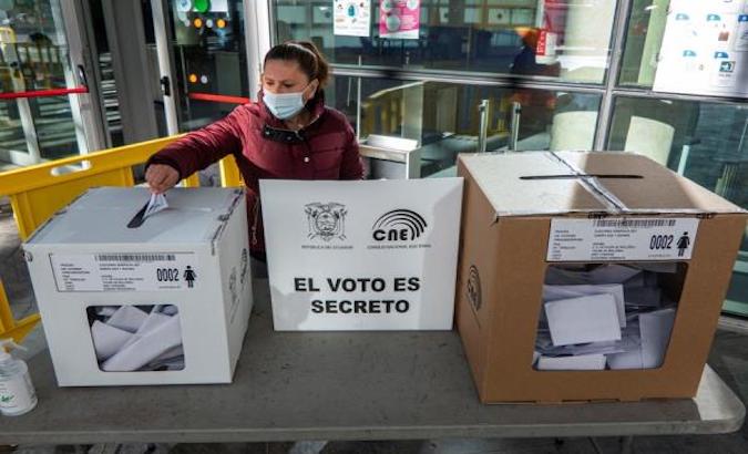 An Ecuadorian woman casts her vote at a polling station in Mallorca, Spain, Feb. 7, 2021.