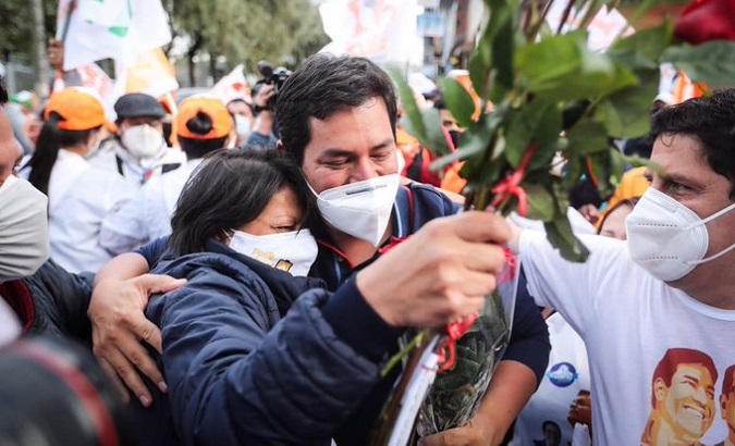 Andres Arauz (c) greets his supporters at a rally, Ecuador, 2021.