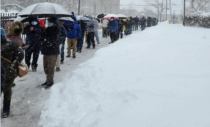 Ecuadorians wait under the snow to cast their vote in New Jersey, U.S., Feb. 7, 2021.