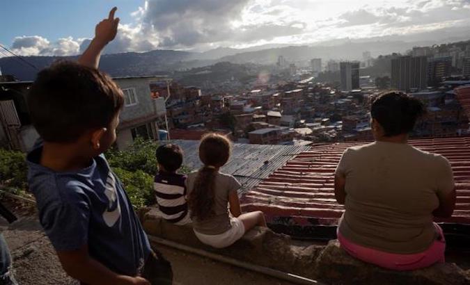 A group of children on their home's rooftop in Petare, Venezuela, Dec. 20, 2021.