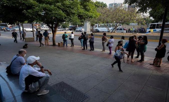 People waiting for public transportation, Caracas, Venezuela, Feb. 8, 2021.