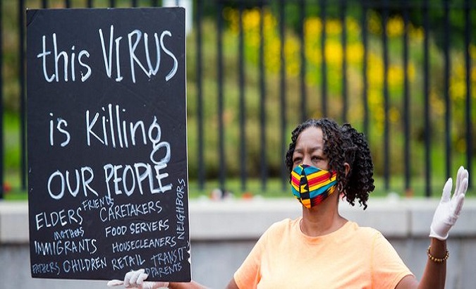 Woman protests against vaccination inequality, Illinois, U.S., Feb. 12, 2021.