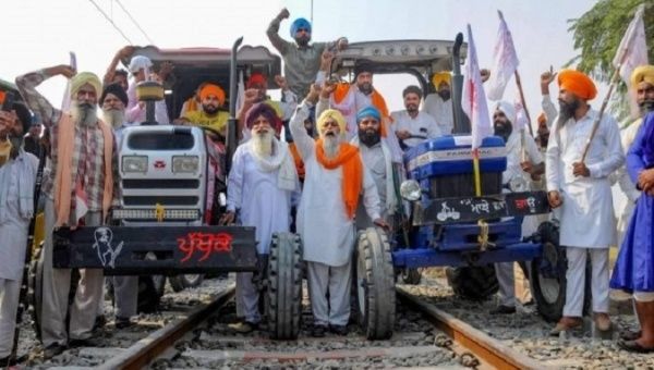 Farmers use their tractors to block train tracks, India, Feb. 18, 2021.