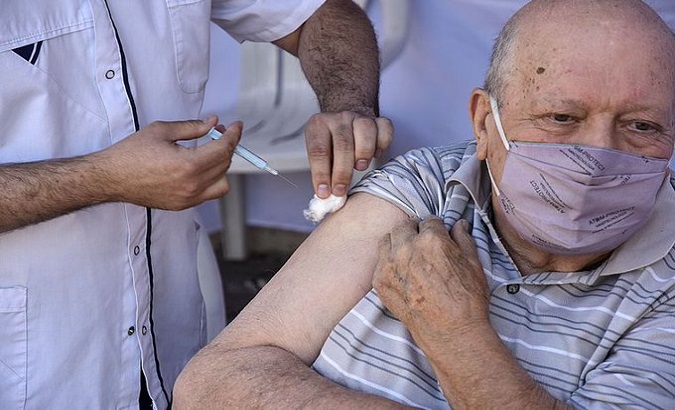 Health worker vaccinates a senior citizen, Argentina, Feb. 24, 2021.