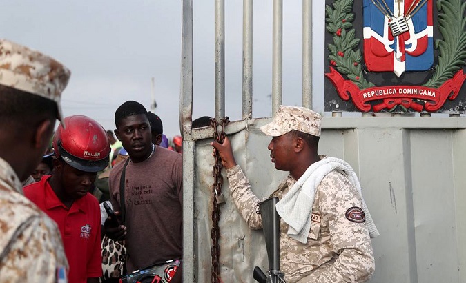 An official performs security control at the Haiti-Dominican Republic border.