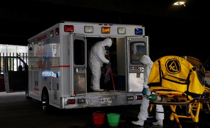Health workers clean an COVID-19 patients ambulance, Mexico, March 1, 2021.