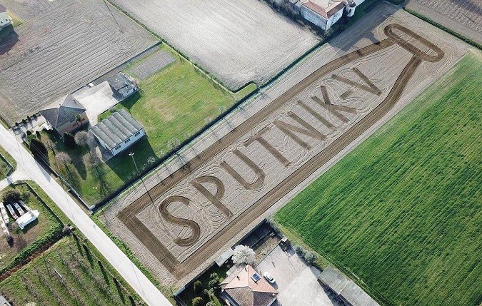 Italian land artist Dario Gambarin makes a 13 000 m2 Sputnik V vaccine flask image in a field in Northern Italy.