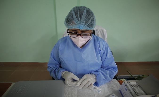 A nurse prepares COVID-19 vaccine shots, San Miguelito, Panama, March 8, 2021.