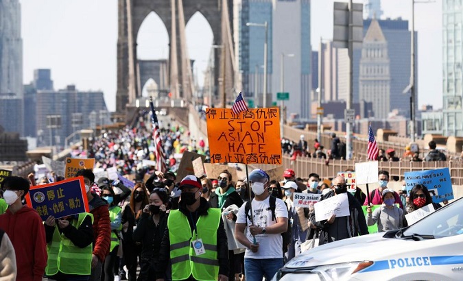 People protest against hate crimes on Brooklyn Bridge in New York, U.S., April 4, 2021.