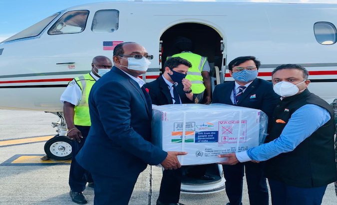 Prime Minister Gaston Browne (left) accepts vaccines from India at the VC Bird International Airport in Antigua