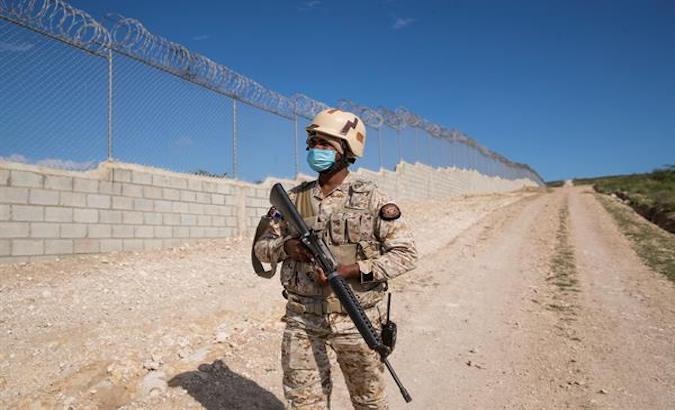 Soldiers guard the border fence, Jimani, Dominican Republic, May 10, 2021.