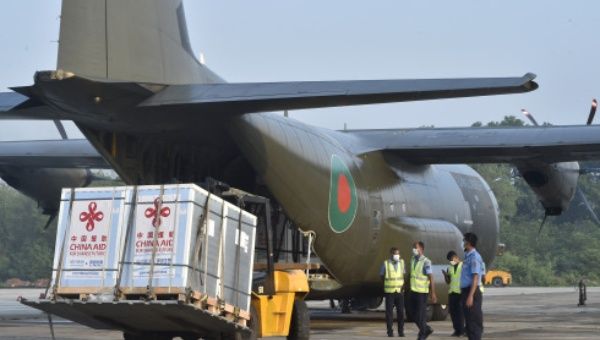A forklift unloads China-donated COVID-19 vaccines from a military transport plane shortly after it landed in Dhaka, Bangladesh, on May 12, 2021