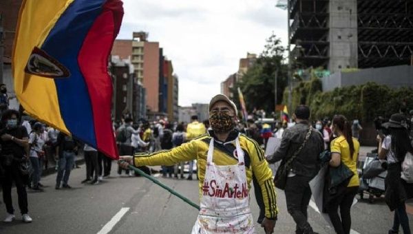 Plastic artist waves a Colombian flag during the national strike, May 25, 2021.