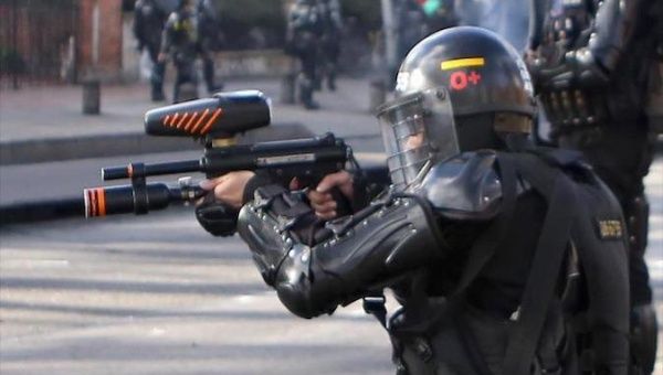 A Mobile Anti-Riot Squad agent targets protesters in Bogota, Colombia, May 2021.