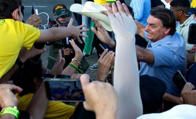 Jair Bolsonaro greets his supporters without wearing a mask, Brasilia, Brazil, May 2021.