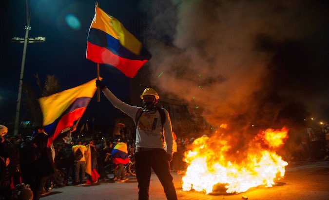 A protester waves a Colombian flag in Bogota, Colombia, May 2021.