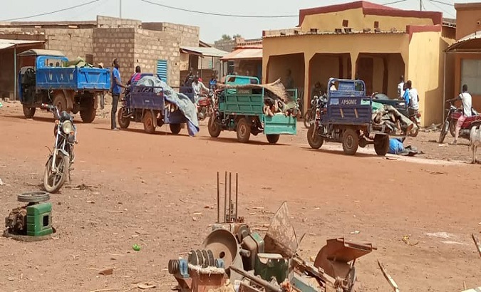 Tricycles carrying bodies to the burial site after the attack, Yagha, Burkina Faso, Jun 5, 2021.