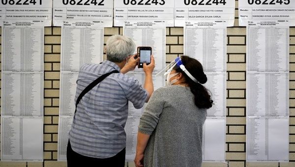 A Peruvian citizen consults voters lists at a polling station in Tokyo, Japan, Jun. 6, 2021.