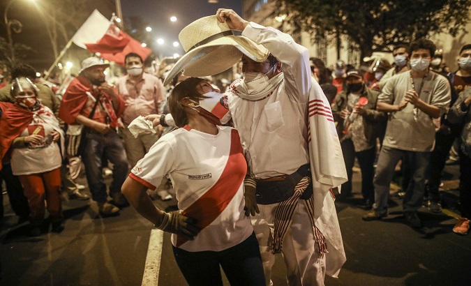 Supporters of presidential candidate Pedro Castillo dance in Lima, Peru, Jun. 11, 2021.