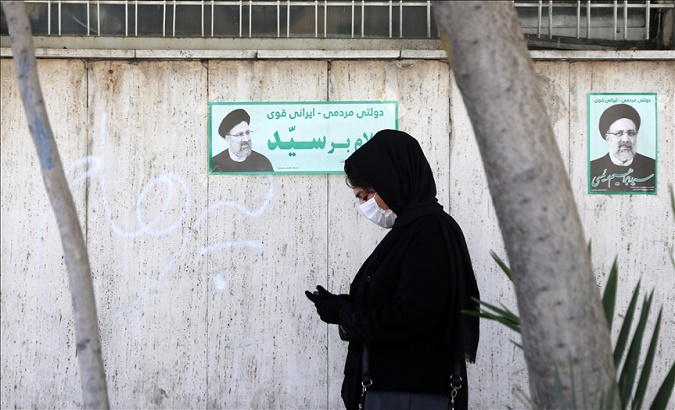 An Iranian woman walks down a street, Tehran, Iran, June 2021.