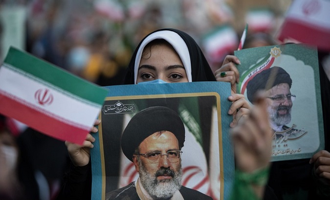 A woman holds a poster of Ebrahim Raisi in Tehran, Iran, June 19, 2021.