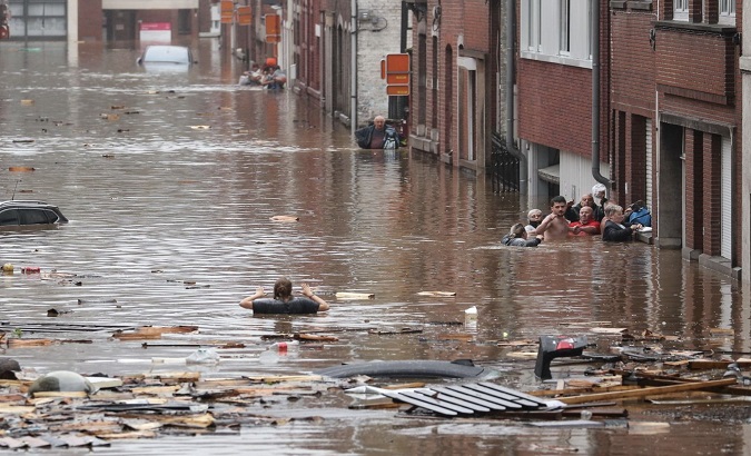 People wait in a flooded street, Germany, Jul 16, 2021.