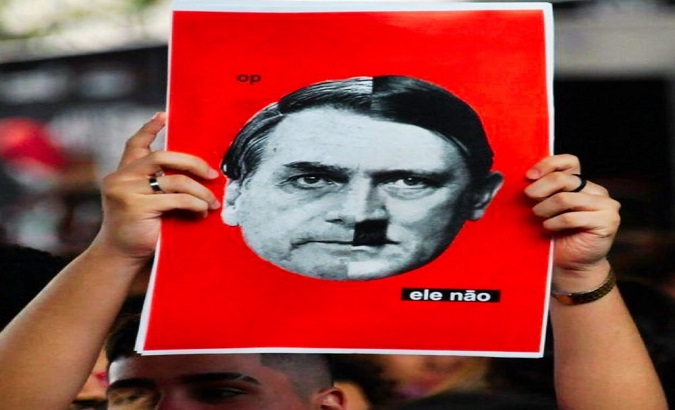 A citizen rises a poster claiming Bolsonaro to be a Nazi-like President, Brasilia, Aug. 15, 2021.