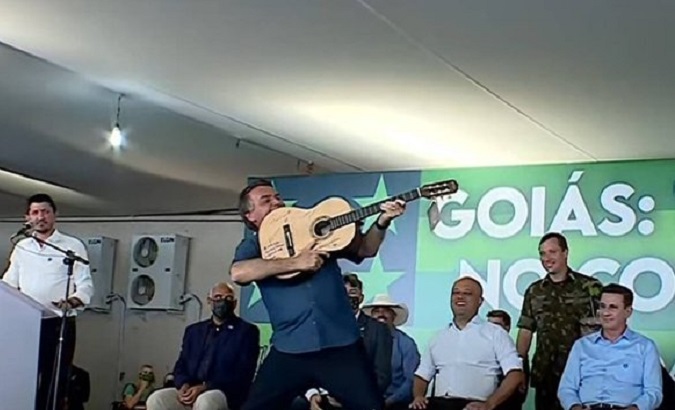 Jair Bolsonaro grabs a guitar and yells 