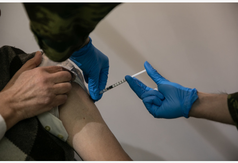 A medical worker administers the COVID-19 vaccine at a vaccination center in Athens, Greece, on April 2, 2021.
