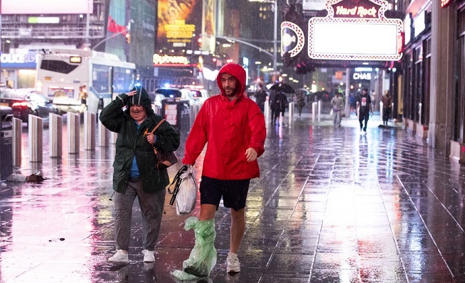 People walk in rain caused by Hurricane Ida, in Times Square, NYC, U.S., Sept. 2, 2021.