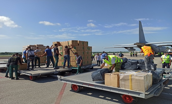 A group of people unloads a donation from Argentina, Havana, Cuba, Sep. 5, 2021.