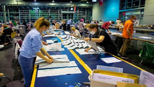 Absentee ballots for the German general election are counted at the Frankfurt Messe hall, Frankfurt am Main, Germany, Sept. 26, 2021.