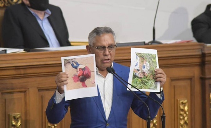 Lawmaker shows photos of murdered adolescents, National Assembly, Caracas, Venezuela, Oct. 14, 2021.