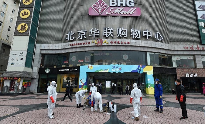 Staff members disinfect a shopping center in Lanzhou, China, Oct. 19, 2021.