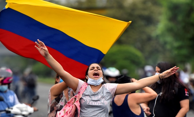 A woman shouts slogans during a demonstration against the tax reform, Cali, Colombia, Apr. 29, 2021.